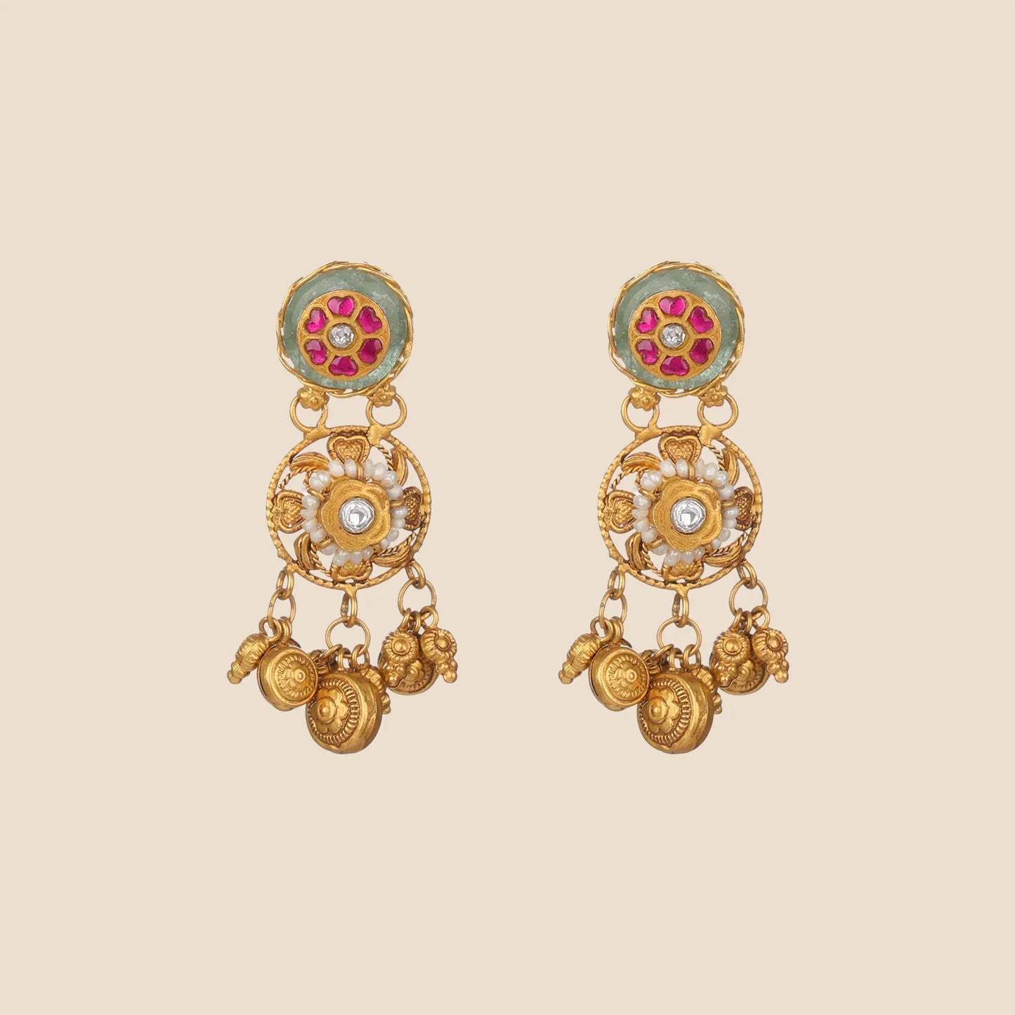Gold dangle earrings featuring a light green circular top with a pink floral inset, an ornate filigree center accented with pearls and a clear stone, and dangling textured gold coin charms.
