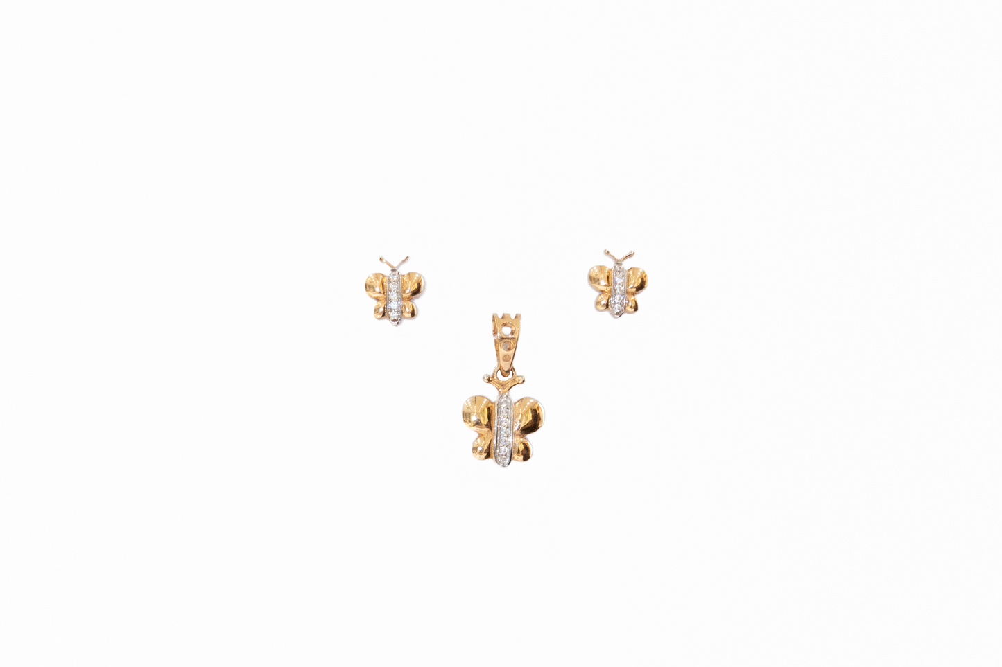 Butterfly-shaped gold pendant and earrings on a white background