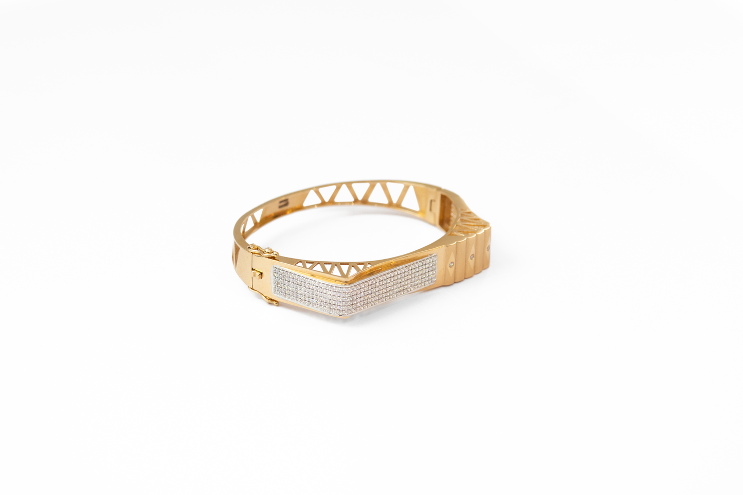 Gold bracelet with geometric design on a white background