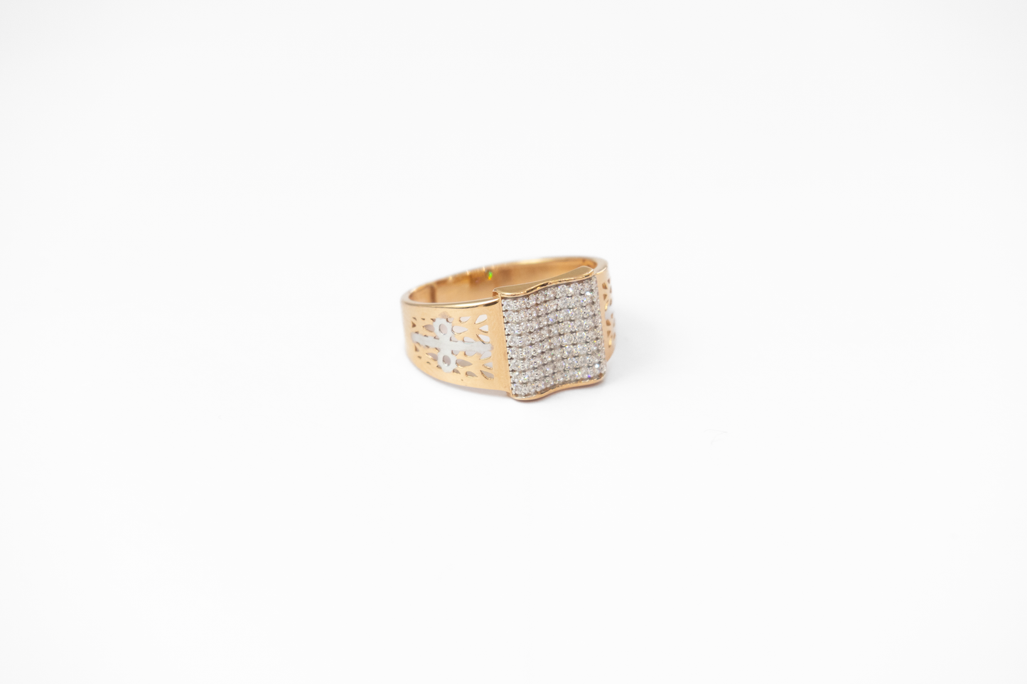 Gold ring with diamond accents on a white background