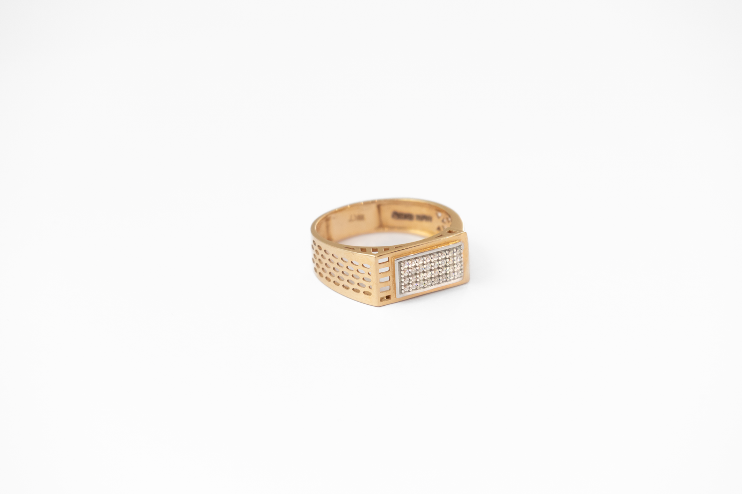 Gold ring with diamond accents on a white background