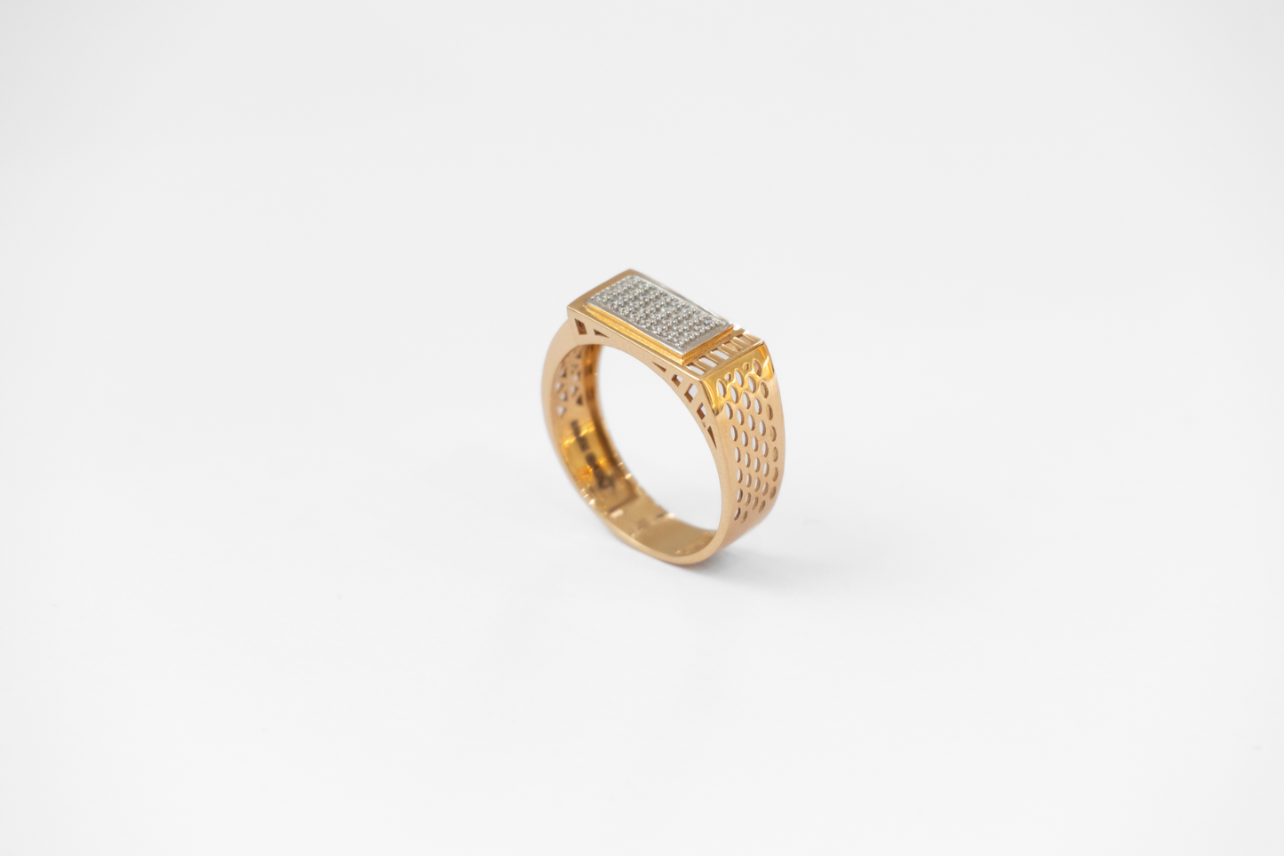 Gold ring with diamond accents on a white background