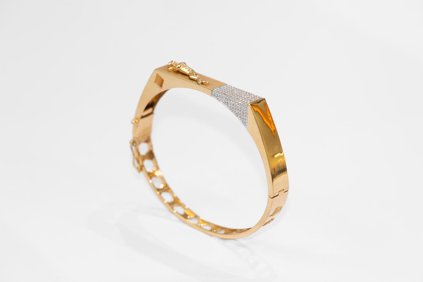 Gold bracelet with diamond accents on a white background