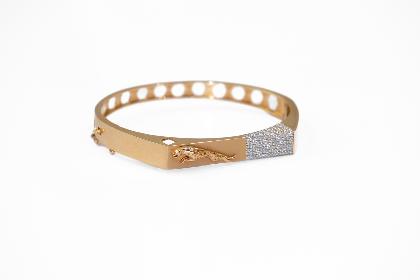 Gold bracelet with diamond accents on a white background