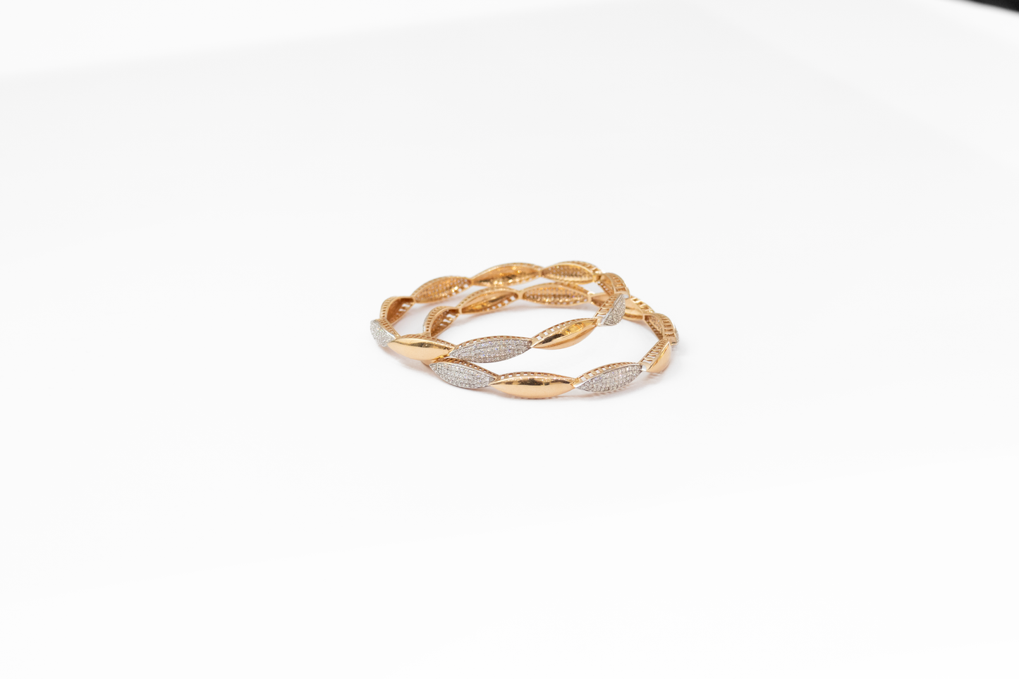 Gold and silver bangles on a white background