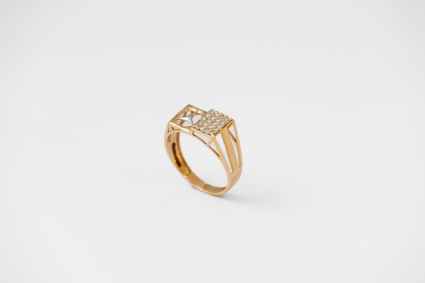 Gold ring with diamond accents on a white background