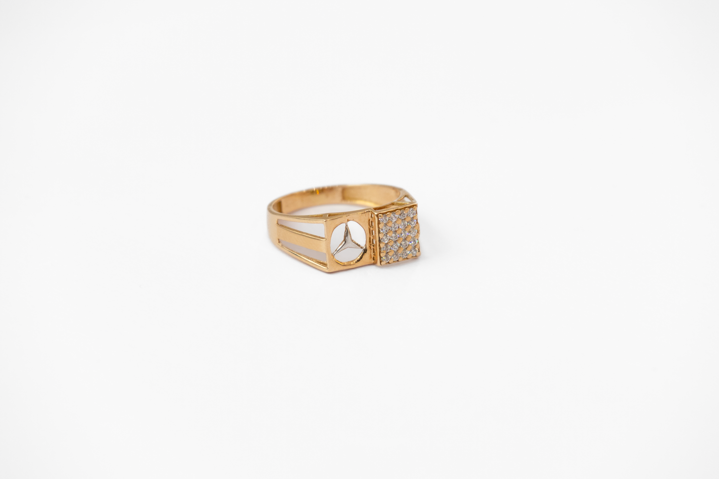 Gold ring with a diamond on a white background