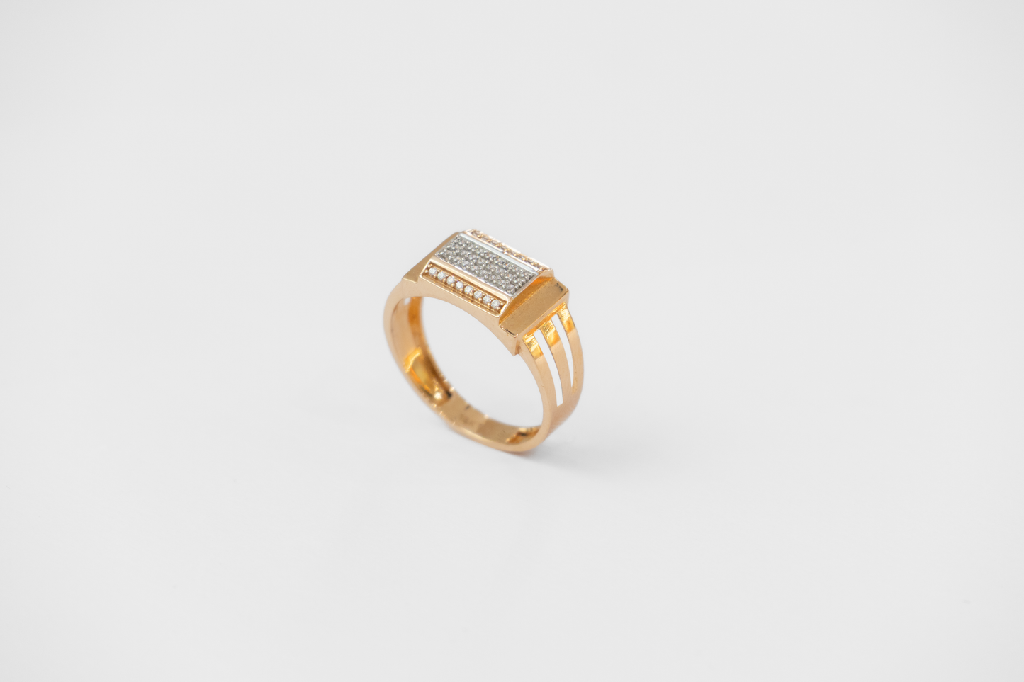 Gold ring with embedded diamonds on a white background