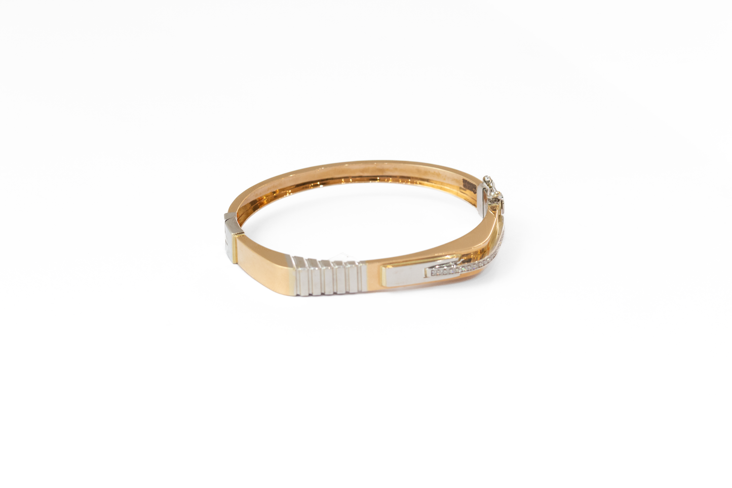 Gold and silver bracelet on a white background