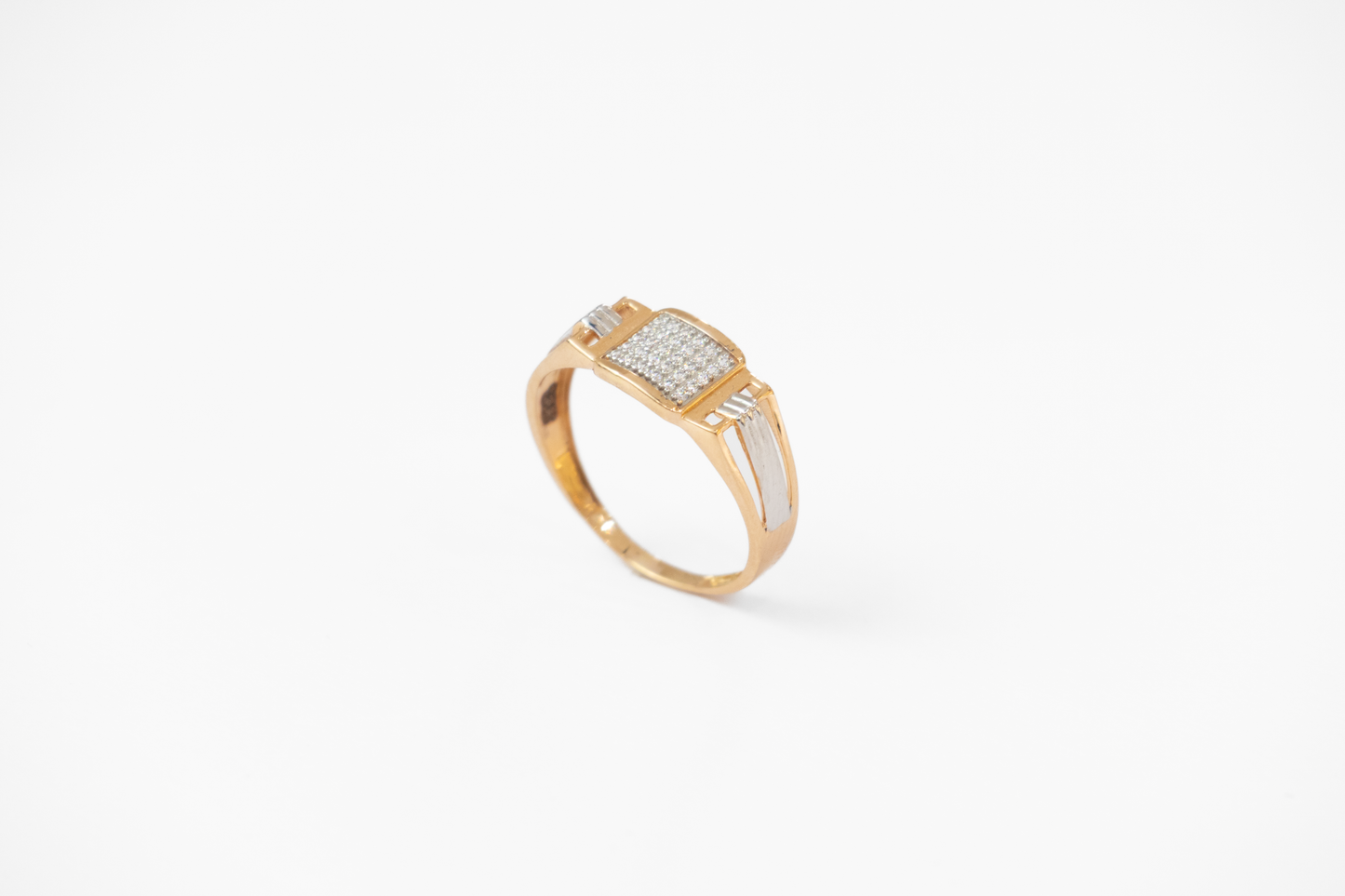 Gold ring with diamond accents on a white background