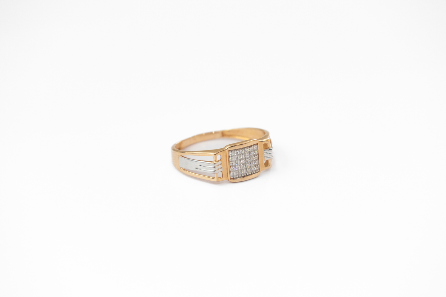 Gold ring with embedded stones on a white background
