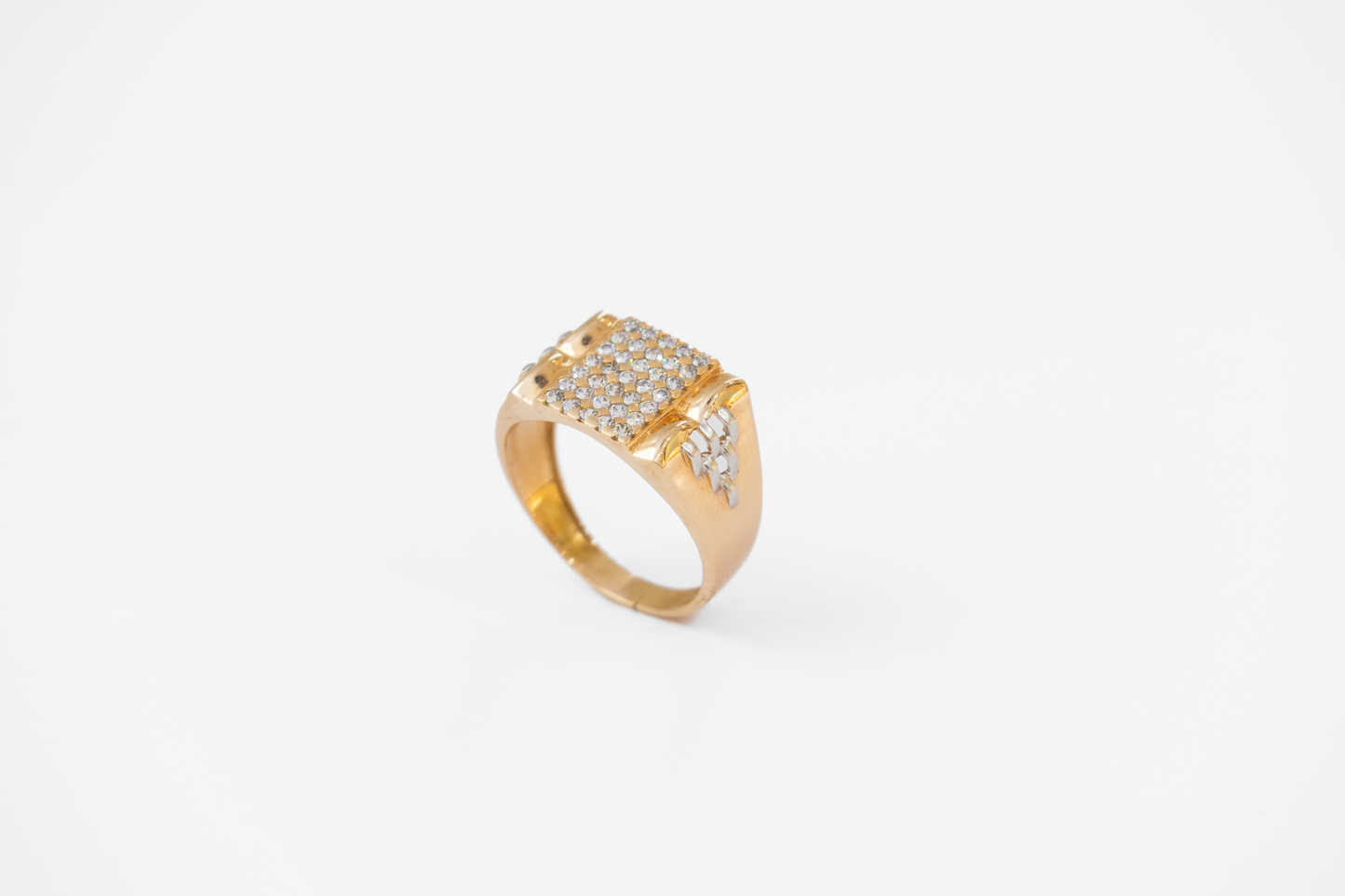 Gold ring with diamond accents on a white background
