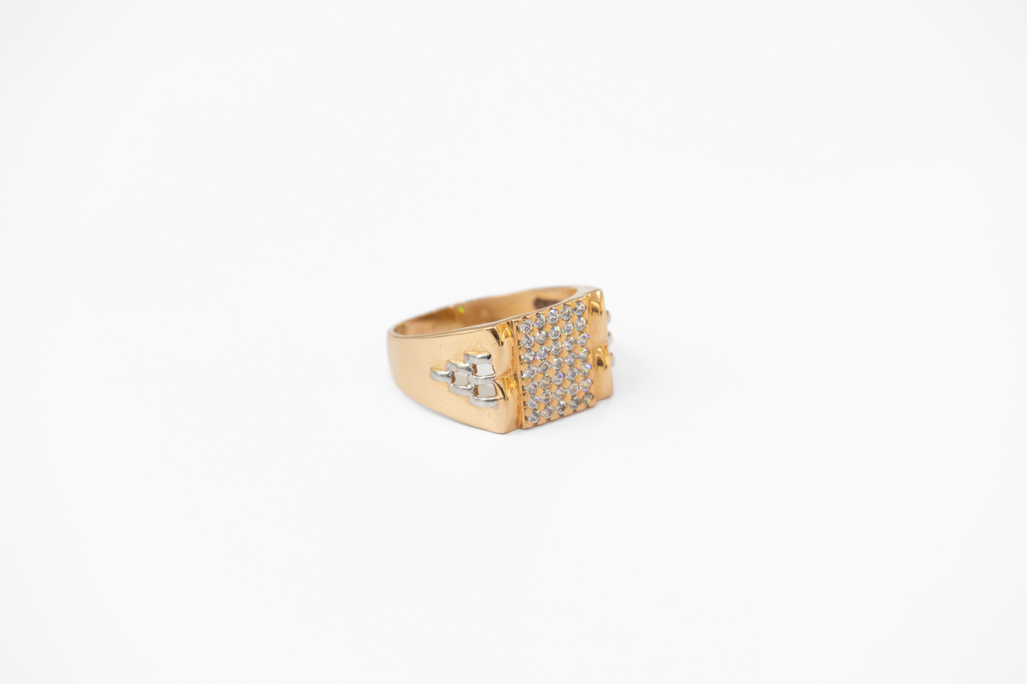 Gold ring with gemstones on a white background