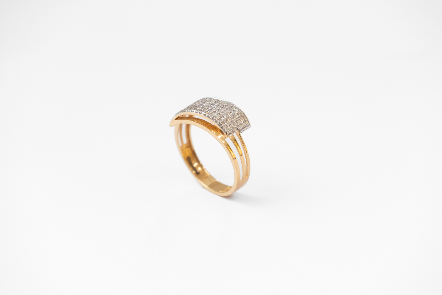 Gold ring with diamond accents on a white background