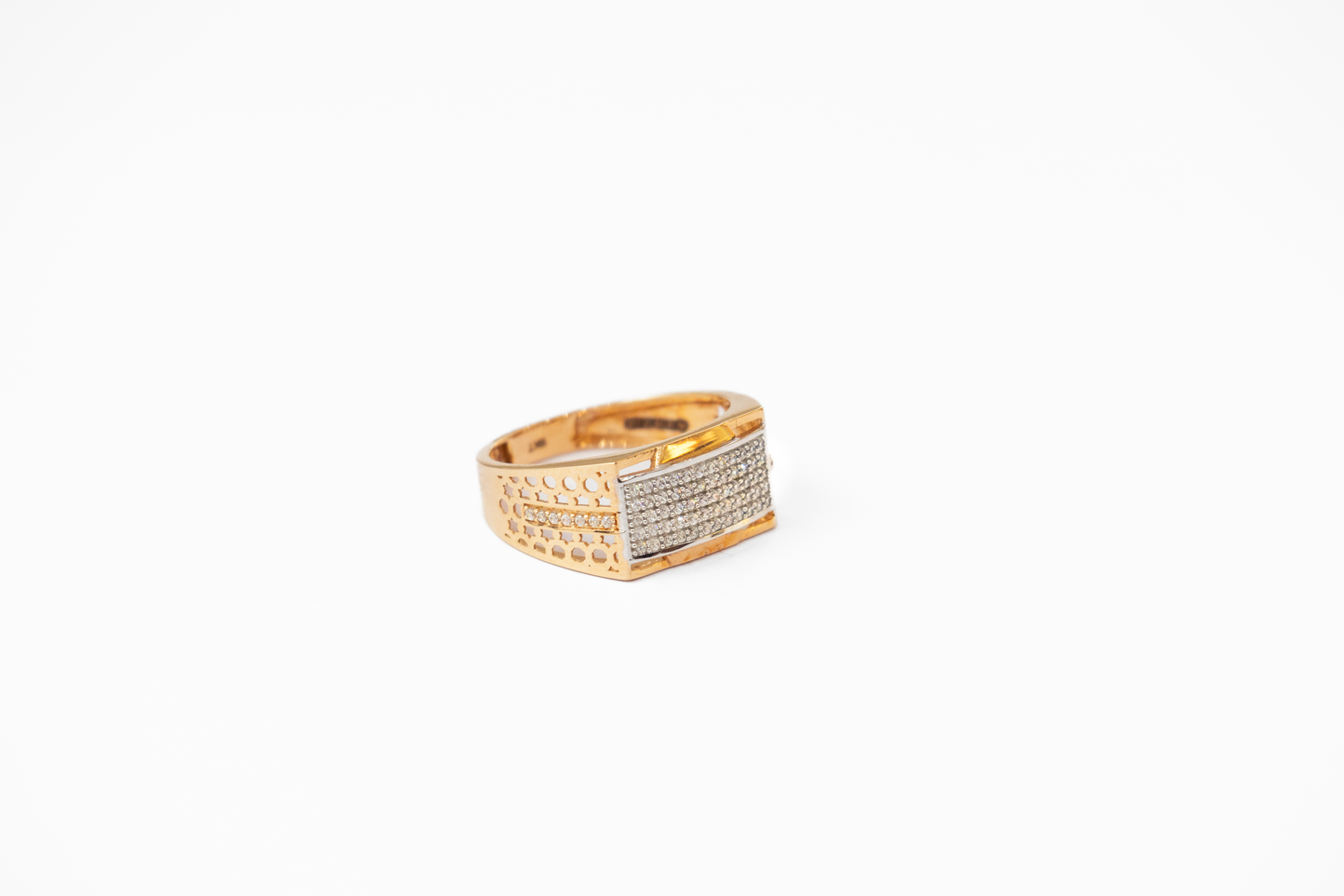 Gold ring with embedded stones on a white background