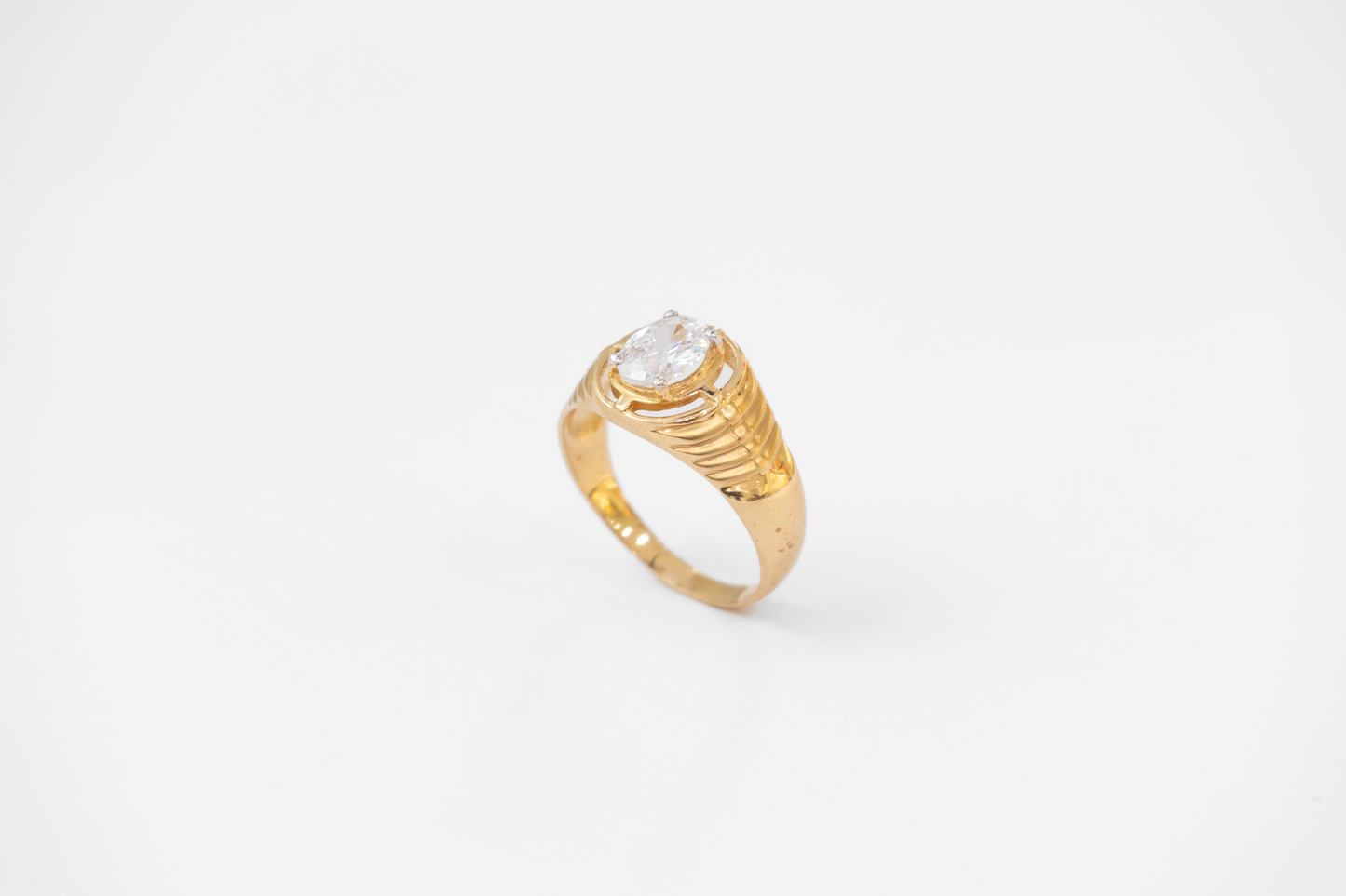 Gold ring with a diamond on a white background