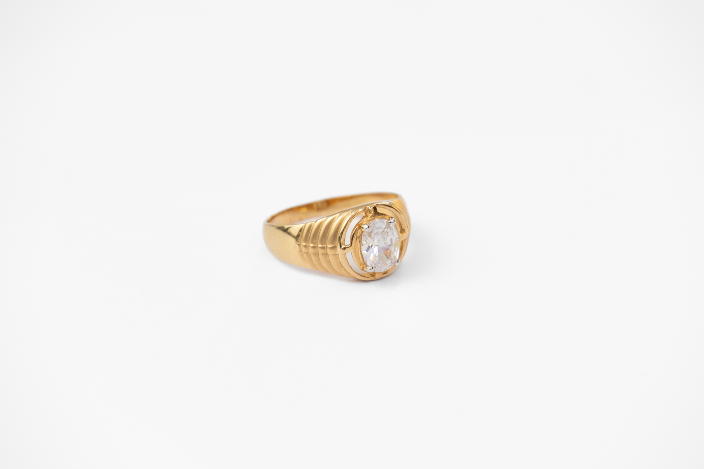 Gold ring with a diamond on a white background